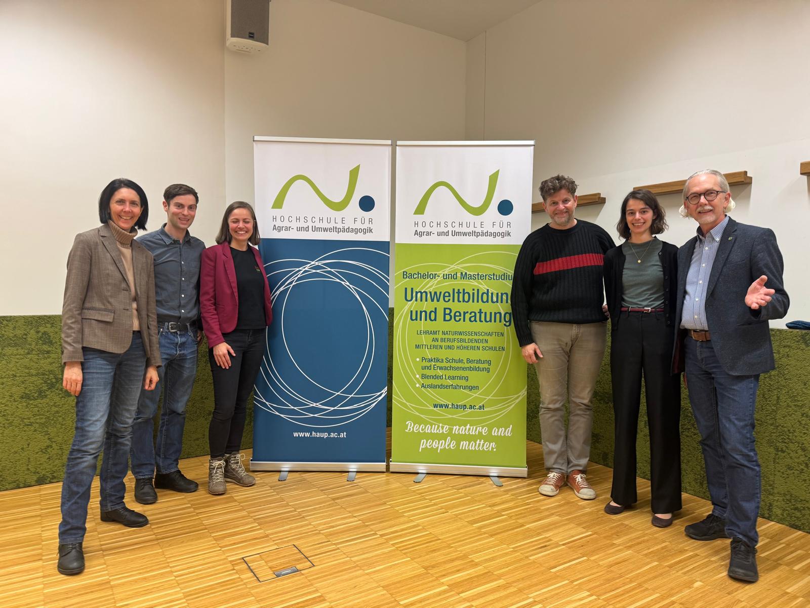 Gruppenfoto mit zwei Roll ups in der Mitte
